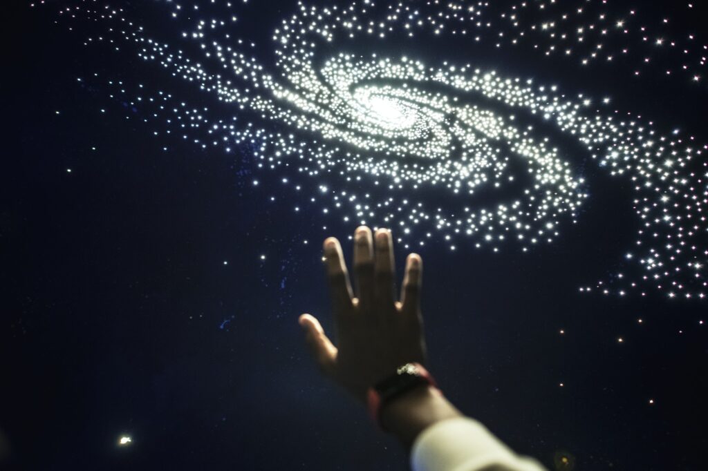 Man experiencing the universe at a planetarium